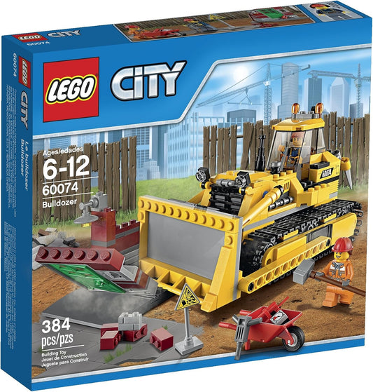 Yellow brick-built demolition bulldozer with front blade beside a partly demolished building section