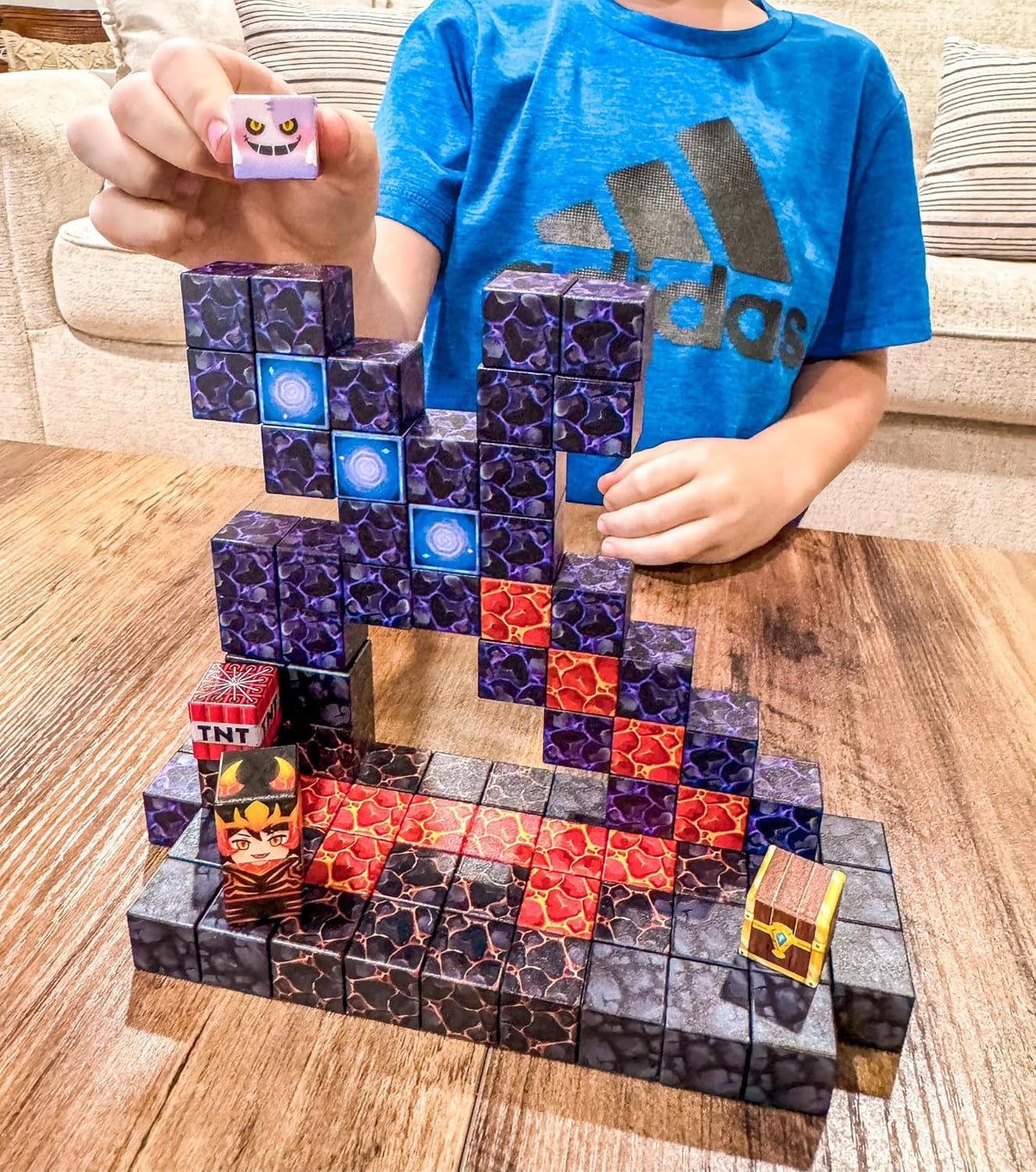 Colorful magnetic cubes built into a small volcano, castle and forest scene